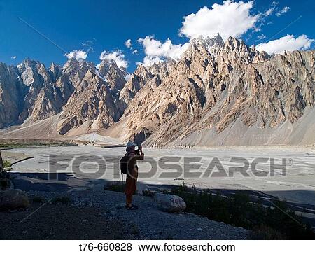 Traveler admires the magnificent Passu Cathedrals, Karakoram Range, Pakistan View Large Photo Image Stock Photo - Traveler admires the magnificent Passu Cathedrals, Karakoram Range, Pakistan. Fotosearch
