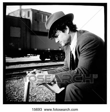 Stock Image - Traveler reading the newspaper. Fotosearch