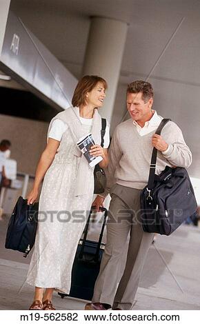 traveling couple at an airport View Large Photo Image Stock Image - traveling couple at an airport. Fotosearch