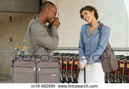 traveling couple at an airport View Large Photo Image Stock Photography - traveling couple at an airport. Fotosearch