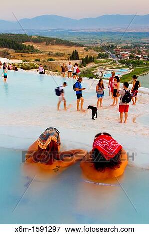 Stock Photo - Travertine terrace formations and tourists Pamukkale Denizli province Anatolia Turkey. Fotosearch