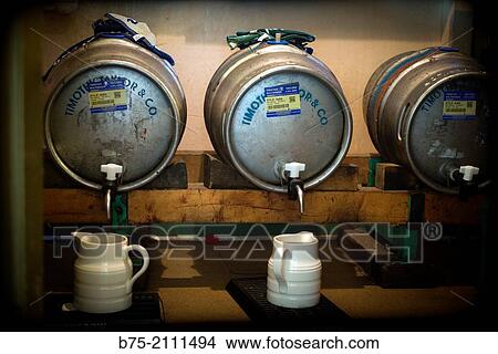 Tree barrels of beer with jugs, Timothy Taylor's brand in a pub in Yorkshire Dales, England, UK, Europe. View Large Photo Image Picture - Tree barrels of beer with jugs, Timothy Taylor's brand in a pub in Yorkshire Dales, England, UK, Europe.. Fotosearch