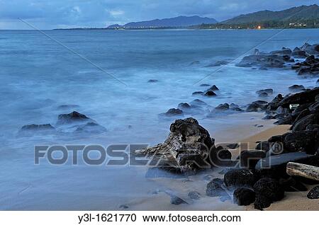 Tree trunk and rocks partially submerged in sea at sunrise long exposure, Kauai Island, Hawaii Islands, USA View Large Photo Image Stock Image - Tree trunk and rocks partially submerged in sea at sunrise long exposure, Kauai Island, Hawaii Islands, USA. Fotosearch