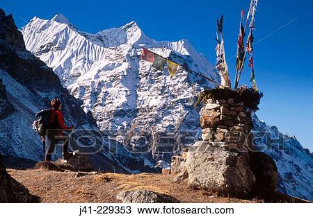 Stock Image - Trekker beside chorten, under Mera Peak (6461m). Lhonak. Kangchenjunga. East Nepal. Fotosearch