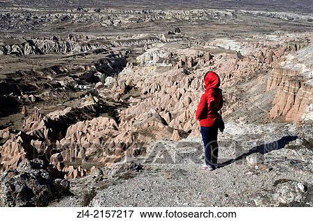Stock Photo - Trekker hiking in the Rose Valley among the fairy chimneys. Turkey, Central Anatolia, Nevsehir Province, Cappadocia, Goreme national park. Model Released.. Fotosearch