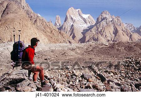 Trekker on Baltoro glacier, unnamed Trango spire behind. Karakoram mountains, Pakistan View Large Photo Image Picture - Trekker on Baltoro glacier, unnamed Trango spire behind. Karakoram mountains, Pakistan. Fotosearch
