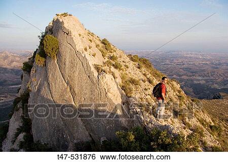 Trekker on the top of the Vent? s. City if Alicante in background. Valencian Community, Spain View Large Photo Image Stock Photograph - Trekker on the top of the Vent? s. City if Alicante in background. Valencian Community, Spain. Fotosearch