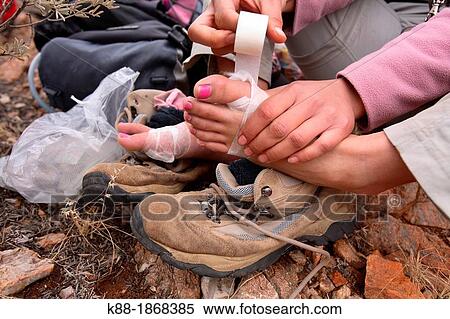 Stock Photography - Trekker with sore feet Larapinta Trail, West McDonnell Ranges, Central Australia. Fotosearch