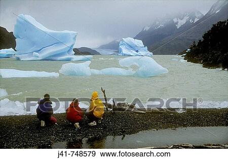 Stock Photo - Trekkers view icebergs in Lago Grey Torres del Paine National Park Patagonia Chile. Fotosearch