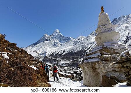 Trekkers walking below Ama Dablam mountain, Everest Region, Nepal View Large Photo Image Stock Photograph - Trekkers walking below Ama Dablam mountain, Everest Region, Nepal. Fotosearch
