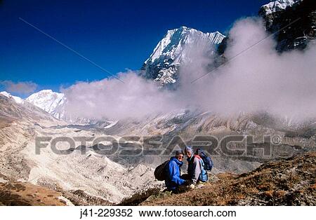 Trekkers. Wedge Peak above cloud. Lhonak. Kangchenjunga. East Nepal View Large Photo Image Stock Image - Trekkers. Wedge Peak above cloud. Lhonak. Kangchenjunga. East Nepal. Fotosearch