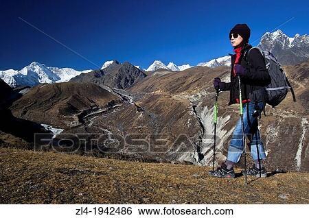 Stock Photograph - Trekking in Gokyo valley, Cho Oyu 8188m in the background. Nepal, Sagarmatha, Gokyo valley. Model Released.. Fotosearch