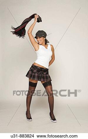 Picture - Trendy model playing with scarf in a studio setting. Fotosearch