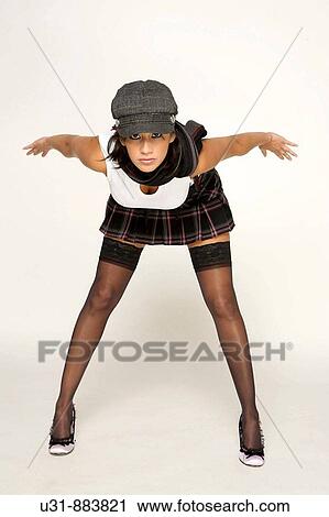 Trendy model pretending to be flying in a studio setting View Large Photo Image Stock Image - Trendy model pretending to be flying in a studio setting. Fotosearch