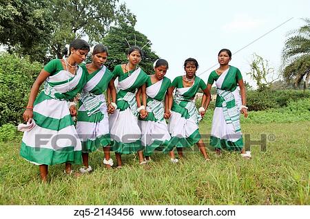 Stock Photograph - Tribal girls performing a typical tribal dance in traditional outfits. Oraon tribe. Hurhuru area of District Hazaribaug, Jharkhand, India.. Fotosearch