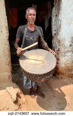 Tribal musician playing a traditional musical instrument known as Nagada. Uraov tribe. Baludih village, Bokaro district, Jharkhand. View Large Photo Image Stock Photo - Tribal musician playing a traditional musical instrument known as Nagada. Uraov tribe. Baludih village, Bokaro district, Jharkhand.. Fotosearch