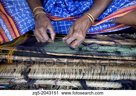 Stock Image - Tribal woman weaving thread, Orissa, India.. Fotosearch
