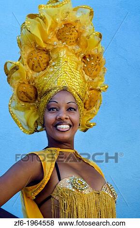 Trinidad Cuba dancer in show costume gold against blue wall and colorful head dress and smile. View Large Photo Image Stock Photo - Trinidad Cuba dancer in show costume gold against blue wall and colorful head dress and smile.. Fotosearch