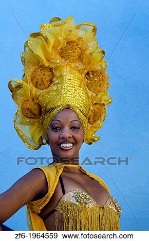 Trinidad Cuba dancer in show costume gold against blue wall and colorful head dress and smile. View Large Photo Image Stock Photo - Trinidad Cuba dancer in show costume gold against blue wall and colorful head dress and smile.. Fotosearch