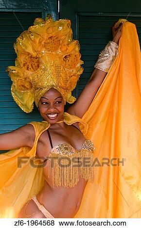 Trinidad Cuba dancer in show costume gold against green door and colorful head dress and smile. View Large Photo Image Stock Photo - Trinidad Cuba dancer in show costume gold against green door and colorful head dress and smile.. Fotosearch