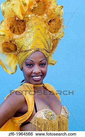 Trinidad Cuba dancer in show costume gold against blue wall and colorful head dress and smile. View Large Photo Image Stock Photograph - Trinidad Cuba dancer in show costume gold against blue wall and colorful head dress and smile.. Fotosearch