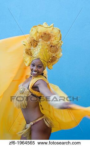 Trinidad Cuba dancer in show costume gold against blue wall and colorful head dress and smile. View Large Photo Image Stock Photography - Trinidad Cuba dancer in show costume gold against blue wall and colorful head dress and smile.. Fotosearch