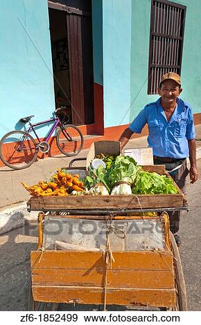 Trinidad Cuba old man with vegetable cart selling fruit on cobbled streets of the old colonial town View Large Photo Image Stock Photo - Trinidad Cuba old man with vegetable cart selling fruit on cobbled streets of the old colonial town. Fotosearch