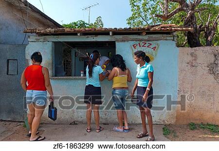 Trinidad Cuba young women buying pizza at local store on street View Large Photo Image Stock Photo - Trinidad Cuba young women buying pizza at local store on street. Fotosearch