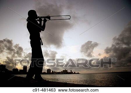 Trombone player in El Malec? n. Havana. Cuba View Large Photo Image Stock Image - Trombone player in El Malec? n. Havana. Cuba. Fotosearch