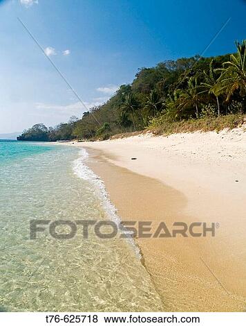 Stock Photo - tropical heaven, one of many deserted beaches in the Bacuit Archipelago, Palawan, Philippines. Fotosearch