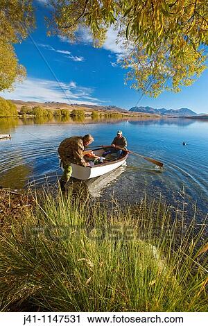Trout fishermen set out for a morning's fishing in rowing boat no engines allowed on lake Lake Alexandrina Wildlife Refuge, Mackenzie country, Canterbury, New Zealand View Large Photo Image Stock Image - Trout fishermen set out for a morning's fishing in rowing boat no engines allowed on lake Lake Alexandrina Wildlife Refuge, Mackenzie country, Canterbury, New Zealand. Fotosearch