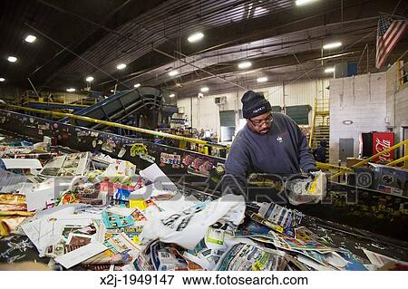 Troy, Michigan - Low-wage workers sort paper, glass, plastic, and metals for recycling at the Southeastern Oakland County Resource Recovery Authority. The materials are picked up in curbside recycling bins at homes in 12 suburban Detroit communities. View Large Photo Image Stock Photo - Troy, Michigan - Low-wage workers sort paper, glass, plastic, and metals for recycling at the Southeastern Oakland County Resource Recovery Authority. The materials are picked up in curbside recycling bins at homes in 12 suburban Detroit communities.. Fotosearch