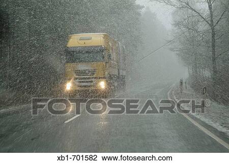 Stock Image - Truck, snowstorm, Germany. Fotosearch