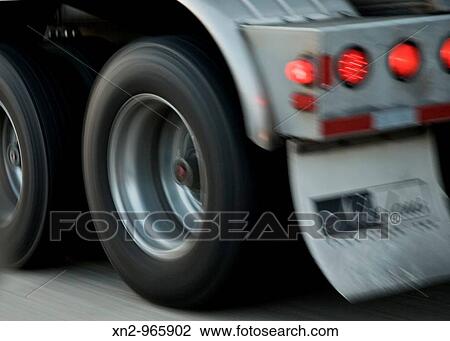 Stock Image - Truck Wheels, Tail Lights - Loang Haul? 18 Wheelers?. Fotosearch