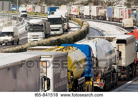 Trucks withheld because of the snow and ice on the highway A-6 in Galicia View Large Photo Image Stock Photo - Trucks withheld because of the snow and ice on the highway A-6 in Galicia. Fotosearch