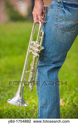 Stock Image - Trumpet held by young man. Fotosearch