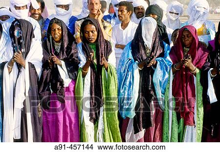 Tuaregs celebrating the Sebiba festival, Djanet. Tassili n? Ajjer, Sahara desert. Algeria View Large Photo Image Picture - Tuaregs celebrating the Sebiba festival, Djanet. Tassili n? Ajjer, Sahara desert. Algeria. Fotosearch