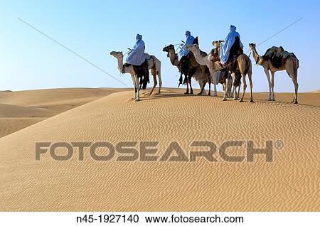 Tuaregs riding Camels; Tuareg Caravan; Libyan Arab Jamahiriya; Libyan Desert. View Large Photo Image Stock Image - Tuaregs riding Camels; Tuareg Caravan; Libyan Arab Jamahiriya; Libyan Desert.. Fotosearch