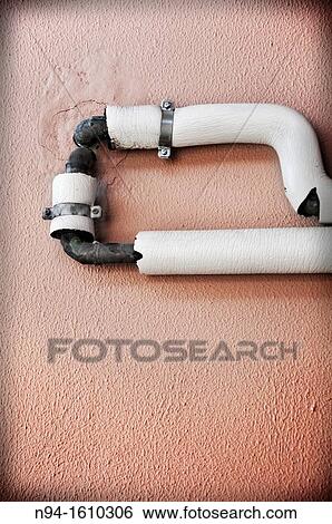 Tubes attached to the wall for power. View Large Photo Image Stock Photograph - Tubes attached to the wall for power.. Fotosearch