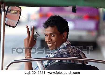 Stock Image - Tuk Tuk Driver in Phnom Penh, Cambodia. Fotosearch