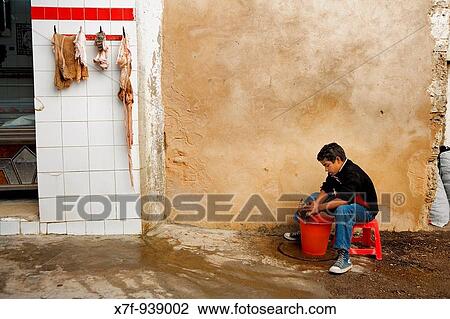 Tunez: Sfax Medina Butcher's shop Child cleaning a goat head View Large Photo Image Stock Image - Tunez: Sfax Medina Butcher's shop Child cleaning a goat head. Fotosearch