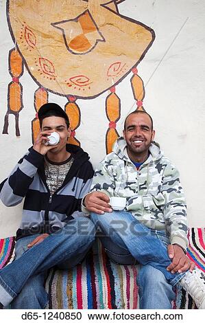 Stock Image - Tunisia, Ksour Area, Ksar Haddada, young Tunisian men in coffee shop, R, MR-TUN-10-002 and MR-TUN-10-003. Fotosearch