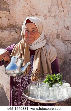 Tunisia, Ksour Area, Metameur, middle-aged Tunisian woman serving tea, R, MR-TUN-10-005 View Large Photo Image Stock Image - Tunisia, Ksour Area, Metameur, middle-aged Tunisian woman serving tea, R, MR-TUN-10-005. Fotosearch