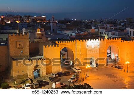 Tunisia, Tunisian Central Coast, Sfax, elevated view of the Medina along Avenue Ali Belhouane and Bab Diwan gate, dusk View Large Photo Image Stock Image - Tunisia, Tunisian Central Coast, Sfax, elevated view of the Medina along Avenue Ali Belhouane and Bab Diwan gate, dusk. Fotosearch