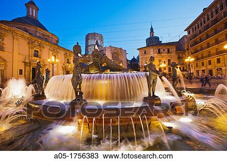 Turia fountain with the Virgen de los Desamparados Basilica and Santa Maria de Valencia Cathedral on the back Plaza de la Virgen Virgin Square at dusk, old area of city, Valencia, Comunidad Valenciana Spain. View Large Photo Image Stock Image - Turia fountain with the Virgen de los Desamparados Basilica and Santa Maria de Valencia Cathedral on the back Plaza de la Virgen Virgin Square at dusk, old area of city, Valencia, Comunidad Valenciana Spain.. Fotosearch
