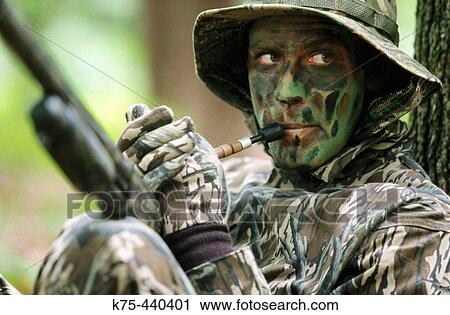 Stock Image - Turkey hunter calling for turkey. Fotosearch