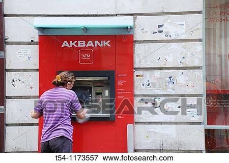 Stock Photo - Turkish Woman clean a ATM in Istanbul. Fotosearch