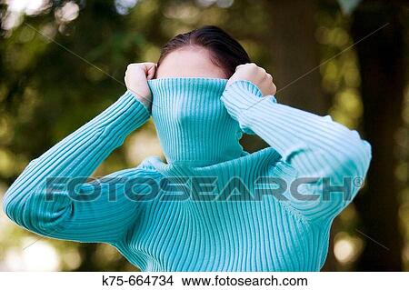 Picture - turleneck over eyes. Fotosearch