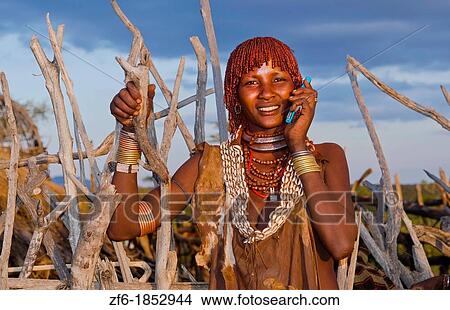 Turmi Ethiopia Africa Lower Omo Valley village with Bena tribe First Wife smiling with jewelry in wild wood camp hut 24 View Large Photo Image Picture - Turmi Ethiopia Africa Lower Omo Valley village with Bena tribe First Wife smiling with jewelry in wild wood camp hut 24. Fotosearch