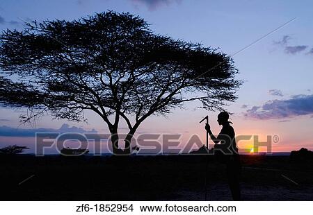 Picture - Turmi Ethiopia Africa Lower Omo Valley village sunset twilight Bena tribe silhouette in sky 24. Fotosearch